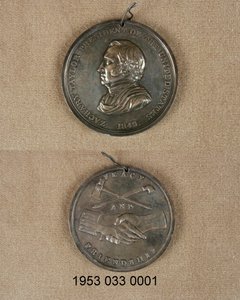 Silver Peace Medal: Obverse has Bust of Zachary Taylor, Reverse has Crossed Pipe and Hatchet above Clasped Hands, One with Uniform Cuff